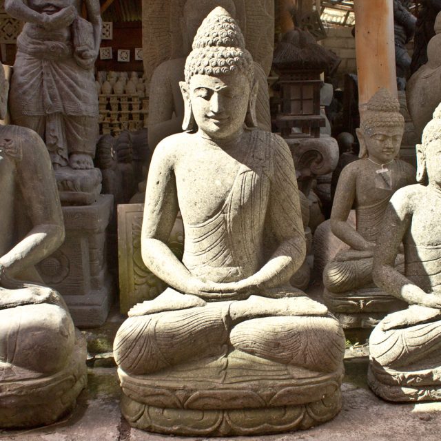 Sitting Buddha stone statue hand carved in a single piece of green stone.